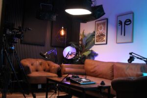 A stylish podcast studio setup with microphones, lights, cameras